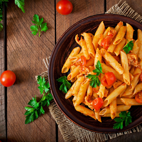 penne-pasta-tomato-sauce-with-chicken-tomatoes-wooden-table_2829-19744